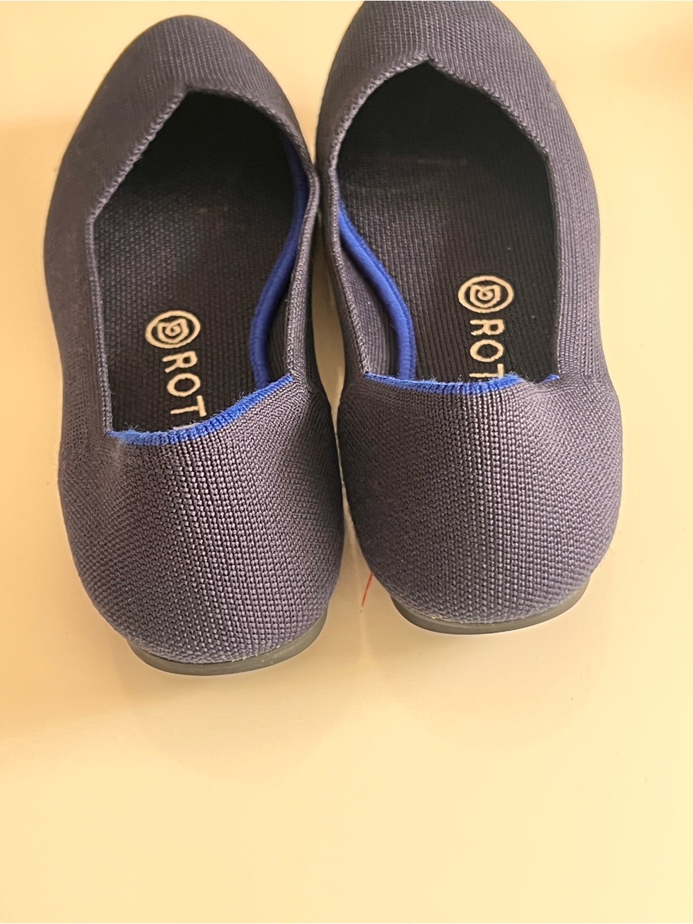 Rothy's navy blue round-toe knit flat shoes featuring a distinctive bright blue - Picture 8 of 12